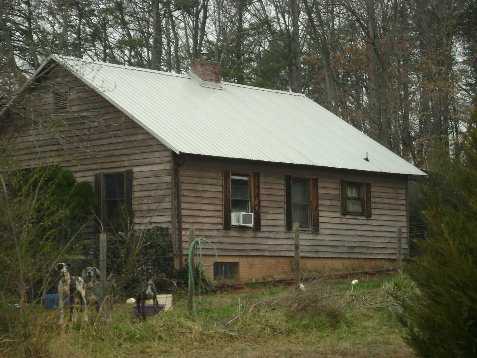 White metal roof on an old wood sided farmhouse, from a Metal Roof Installation job in Camarillo